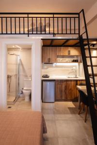 a bedroom with a bunk bed and a bathroom at Sea&Salt Luxury Rooms in Nea Kalikratia