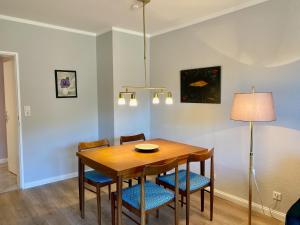 a dining room table with chairs and a lamp at Schöne Aussicht in Lautenthal