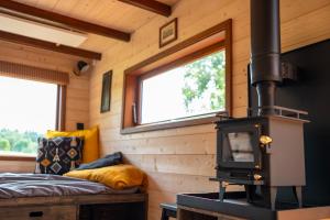 a room with a woodburning stove in a tiny house at Ráj pod Troskami in Semily