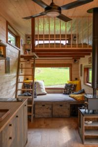 a bedroom in a tiny house with a bunk bed at Ráj pod Troskami in Semily