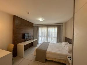 a bedroom with a large bed and a window at Vision Hotel - Flat Particular in Brasília +40 photos