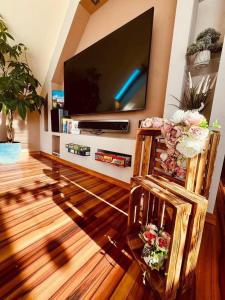 a living room with a flat screen tv on a wall at Spa Residence beltéri jakuzzi inside jakuzzi in Veszprémfajsz