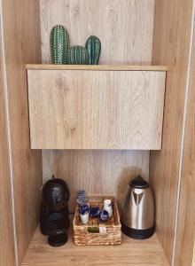 a shelf with a coffee maker and a tea kettle at Casa del Mar in Vlorë