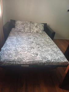 a bed in a room with a bedsheet on it at Beausoleil, 30 meters from Monaco train station in Beausoleil