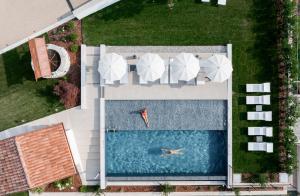 an overhead view of a swimming pool with umbrellas at Agriturismo Prà dell'Ort - Wishing Wellness in Valdobbiadene