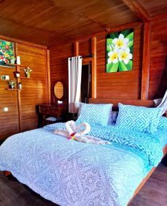 a stuffed animal on a bed in a bedroom at Pondok Denly by Pigeon in Nusa Dua +16 photos