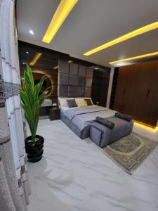 a bedroom with a bed and a potted plant at Super Luxury 3bedroom Apartment in Gbagada in Lagos