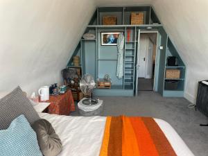 a bedroom with a bed and a room with a attic at The Greenhouse in Portsmouth