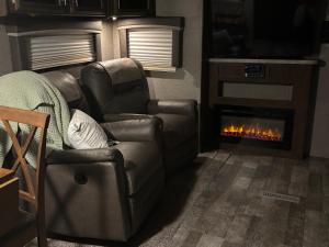 a living room with a couch and a fireplace at Skull Creek custom 2 in Round Top