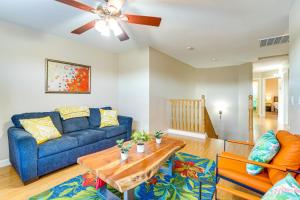 a living room with a blue couch and a table at Avondale Abode Pool, Lake Views and On-Site Fishing in Avondale