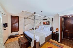 a bedroom with a bed with a canopy at Sonesta Dahabeya Amirat I - Nile Cruise Ship From Luxor to Aswan 7 nights in Luxor