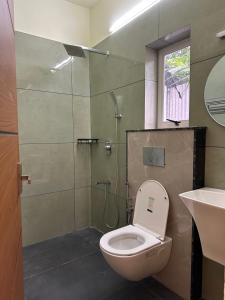 a bathroom with a toilet and a shower and a sink at Vista valley in Kattappana