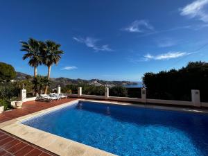 a swimming pool with a view of the ocean at Villa Marietta, private pool villa with sea views and terrace, perfect for families and remote stays in Almuñécar