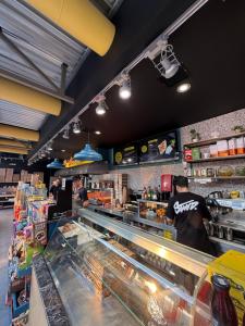 a restaurant with people preparing food in a bakery at Olympos Beach in Plaka Litochorou