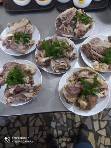 a bunch of plates of food on a table at Humo Hotel and Restaurant in Bŭston