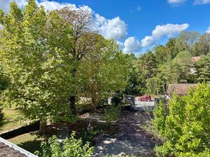 a view of a yard with trees and a truck at Le Douare, Proche centre-ville, Parking in Morestel