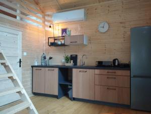 a kitchen with a counter and a refrigerator in a room at Domek Betula Izerska in Świeradów-Zdrój