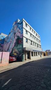 a building with a painting on the side of it at Hotel Riviera in Córdoba