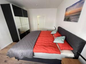 a bedroom with a large bed with red sheets at Dalyan-Home in Boppard