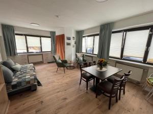 a living room with a couch and a table and chairs at Dalyan-Home in Boppard