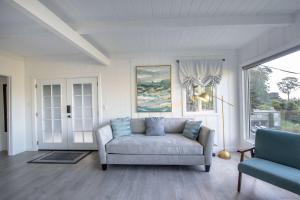 a living room with a couch and a window at Coastal Charm - Oceanview Stay in Pacifica Near SF in Pacifica