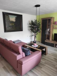 a living room with a couch and a table at Ferienhaus In Breitenstein Mit Grill Und Garten in Breitenstein