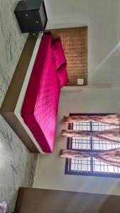 two beds in a room with pink pillows at Jagadeeshwara comforts kalasa in Kalasa