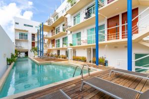 an apartment with a swimming pool and a building at Duplex w Rooftop Plunge Pool – Walk to Beach in Playa del Carmen