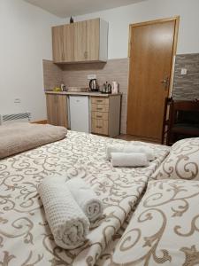 a bedroom with a bed with towels on it at Apartments Nemanja in Žabljak