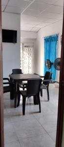a dining room with a black table and chairs at Apartamento independiente amoblado mompox dos aires acondicionado in Mompos +5 photos