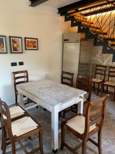 a dining room with a table and chairs at B e B Villa Livia in Rolo +4 photos