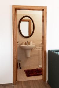 a bathroom with a sink and a mirror at Bed and breakfast Piazza Piè di Corte in Corropoli +21 photos