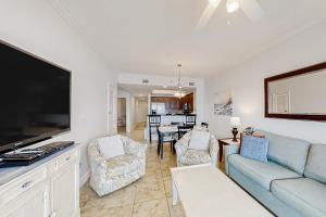 a living room with a couch and a flat screen tv at Seawind 1804 in Gulf Shores