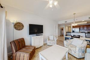 a living room with a couch and a tv at Seawind 1804 in Gulf Shores