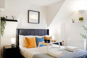 a bedroom with a bed with a table on it at Stylish Studios in Historic City of London, Next to Barbican & Farringdon in London