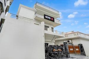 a white building with a sign on the side of it at SPOT ON Manjuvilla in Varanasi +21 photos