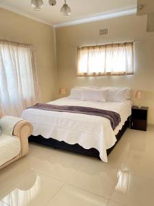 a bedroom with a large bed and a window at Meadway on the parks in Benoni