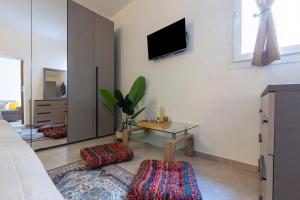 ein Wohnzimmer mit einem Fernseher an der Wand in der Unterkunft White Zagara in Trapani