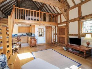 a living room with wooden ceilings and a loft at Courtyard Cottage in Church Stretton