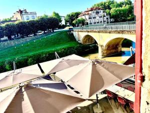a group of umbrellas sitting next to a bridge at La Galupe in Mont-de-Marsan