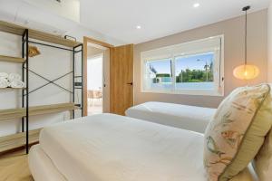 a bedroom with two beds and a window at Island Paradise in Adeje