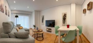 a living room with a couch and a table at Natalia in Allariz