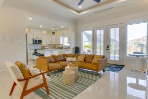 a living room with two couches and a kitchen at Private Backyard Oasis Brownsville Family Home in Brownsville