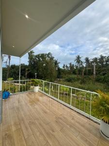 an empty patio with a white railing and a deck at Paradise Villa - 2BR - Private Pool - Peaceful Garden - 4K SmartTV in Thongsala