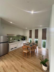 a kitchen and dining room with a table and chairs at Paradise Villa - 2BR - Private Pool - Peaceful Garden - 4K SmartTV in Thongsala