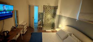 a hotel room with a bed and a television at B&B SMARTFIT HOUSE - Room & Relax in Pescara in Pescara
