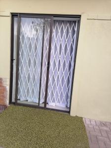 a sliding glass door with a window on a building at Meadway Cosy retreat for 2 in Benoni