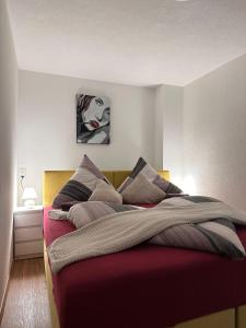 a bedroom with a large bed with a painting on the wall at Apartment Ana in Arzl im Pitztal