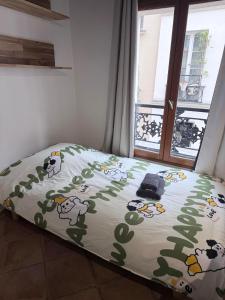 a bed in a room with a comforter with sheep on it at Elegant Studio near Pompidou Center in Paris +2 photos