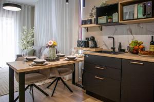 a kitchen with a table and a sink in it at Lobos Dream Flat by Escape to Madeira in Câmara de Lobos